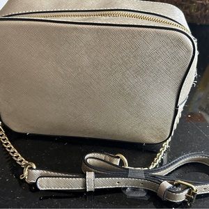 Brand new, with tags metallic handbag with zippers and adjustable strap